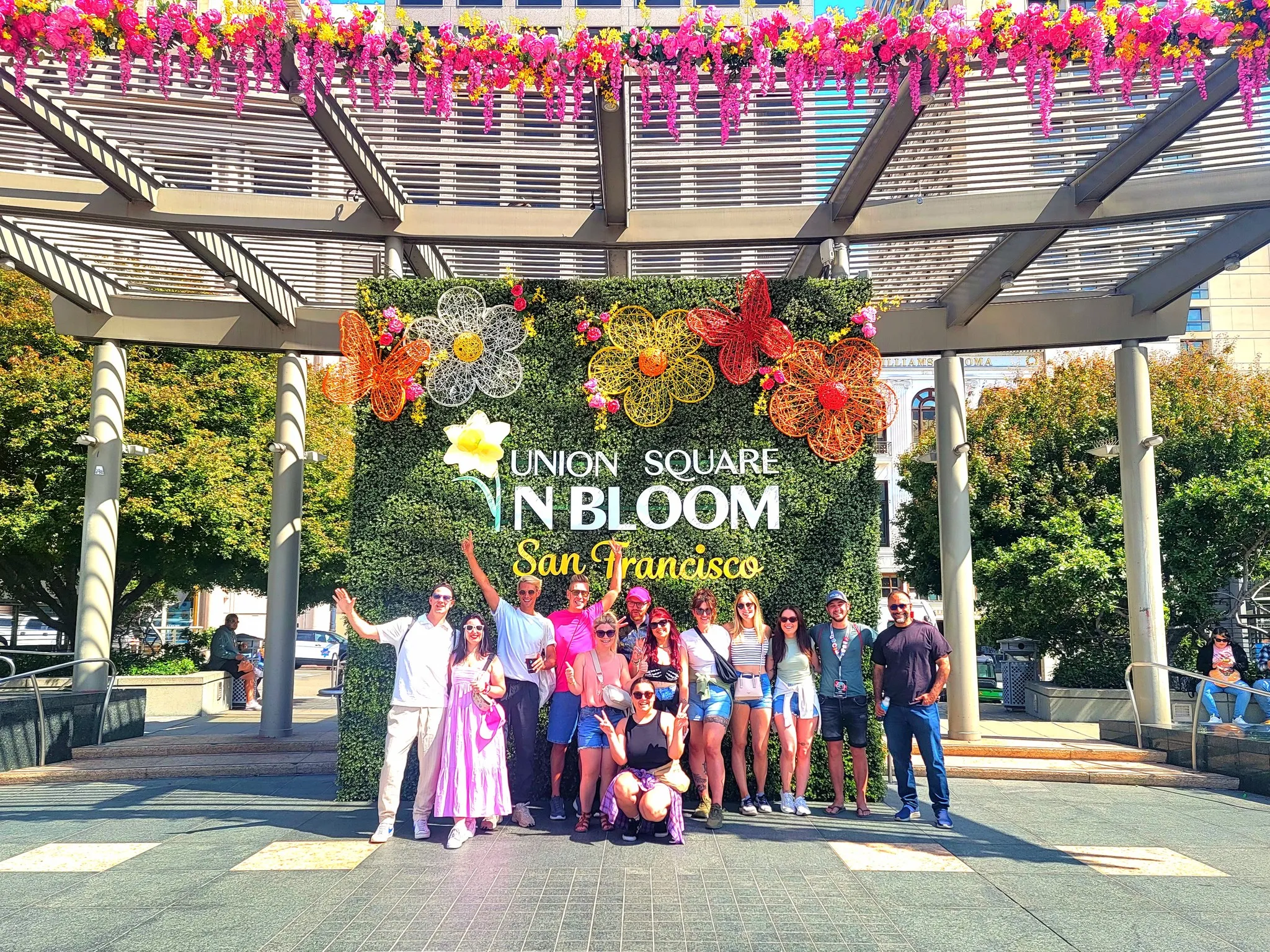 People enjoying a sunny day in Golden Gate Park with flowers and trees